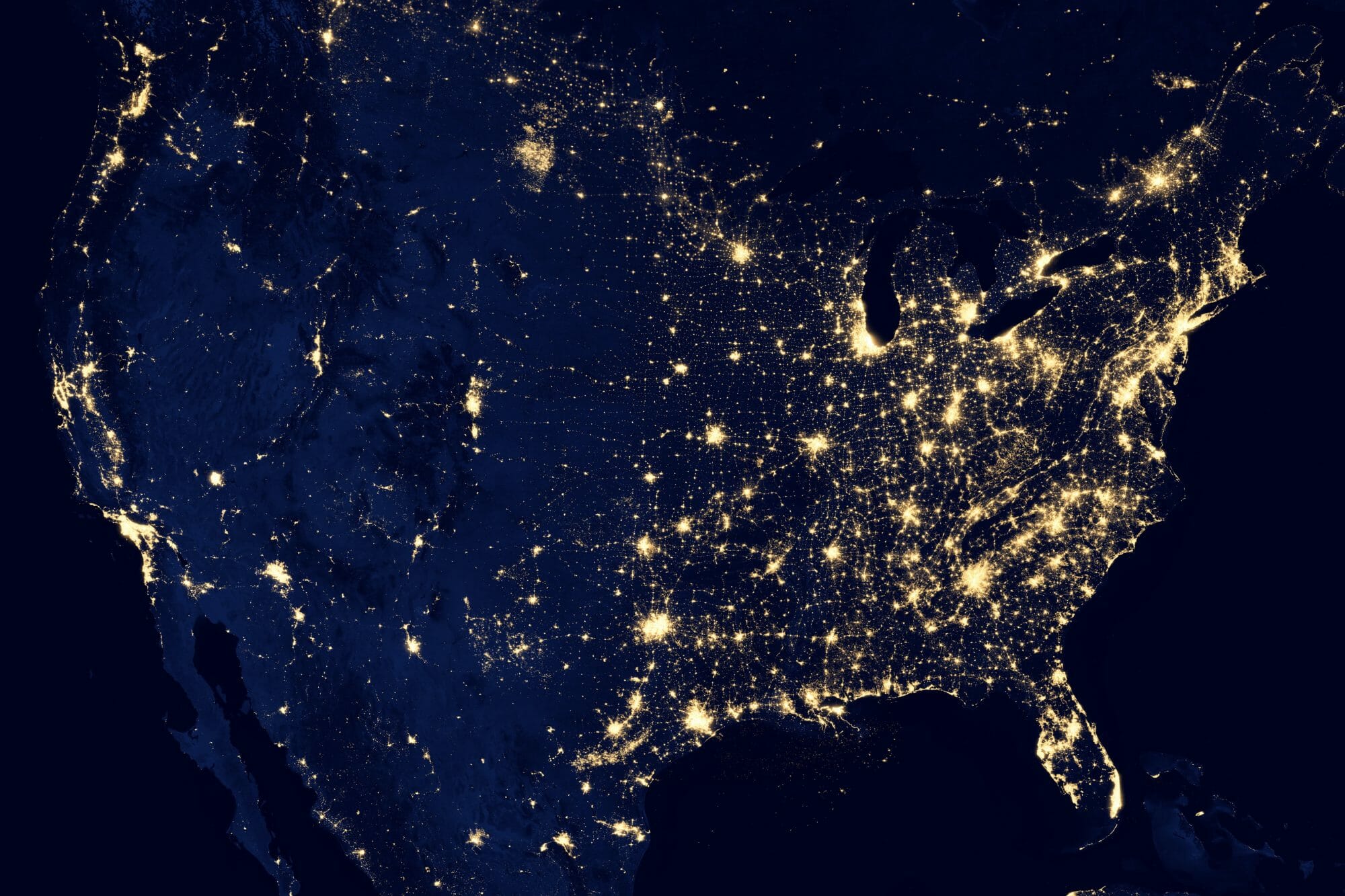 Satellite view of the USA at night showing clusters of city lights
